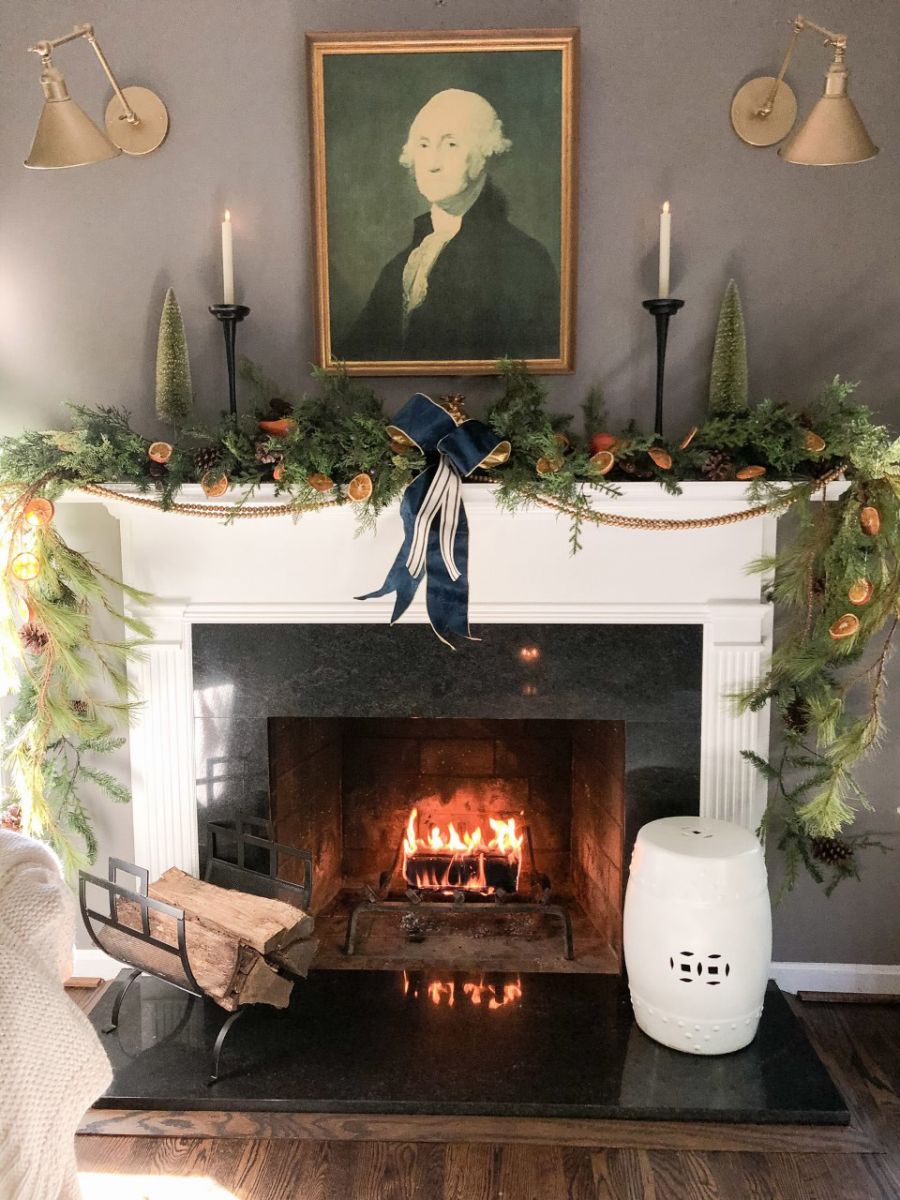 Mixing antique elements with greenery creates a fresh, modern mantle design perfect for any holiday season!